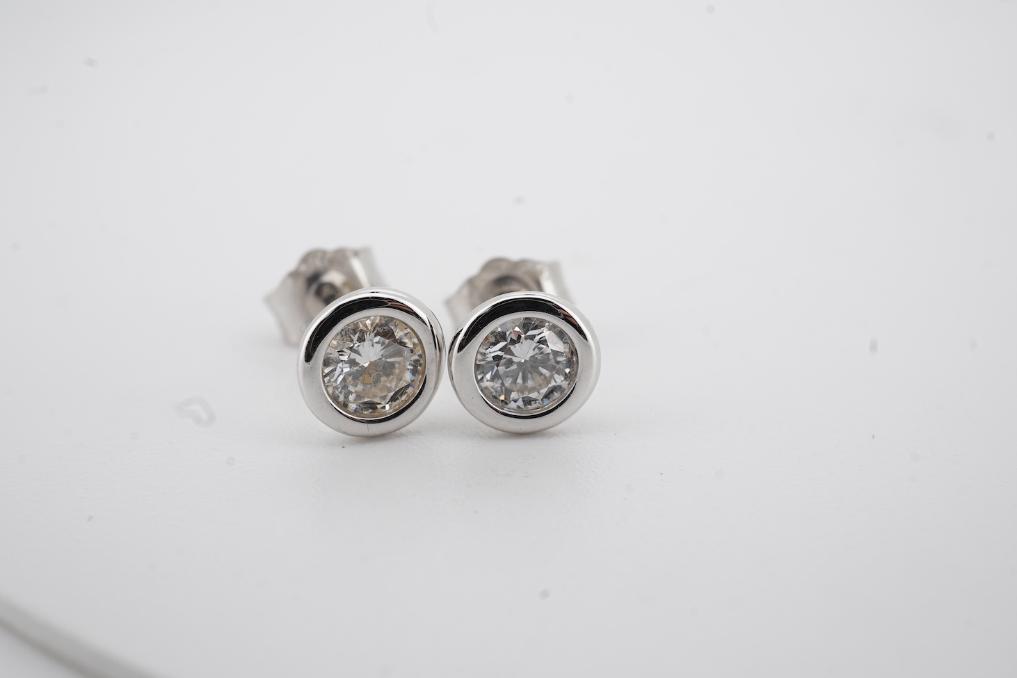 A modern pair of white metal (stamped 375) and solitaire lab-grown synthetic diamond set ear studs, each stone weighing approximately 0.15-0.20ct.